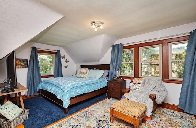bedroom with vaulted ceiling and baseboards