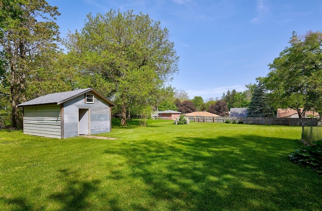 view of yard featuring a storage unit and an outbuilding