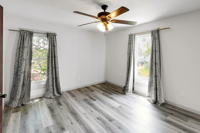 325 E Maple Ave, Ottumwa, IA 52501 - unfurnished room featuring a ceiling fan and wood finished floors
