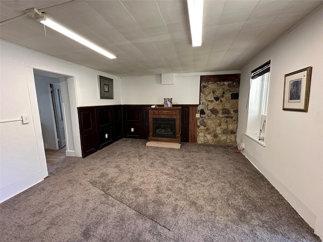 unfurnished living room featuring carpet and a fireplace