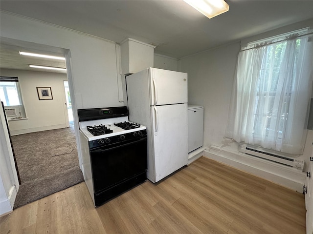 kitchen with range with gas stovetop, baseboard heating, freestanding refrigerator, light wood finished floors, and refrigerator
