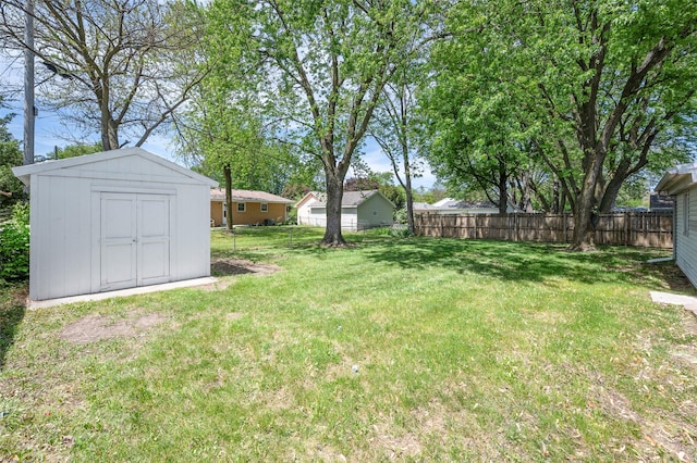 view of yard featuring a storage shed and an outdoor structure