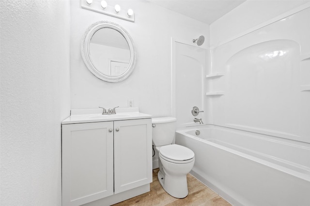 bathroom with wood finished floors, toilet, vanity, and washtub / shower combination