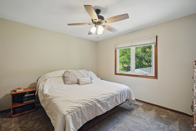 7052 Plum Dr, Urbandale, IA 50322 - carpeted bedroom with baseboards and ceiling fan