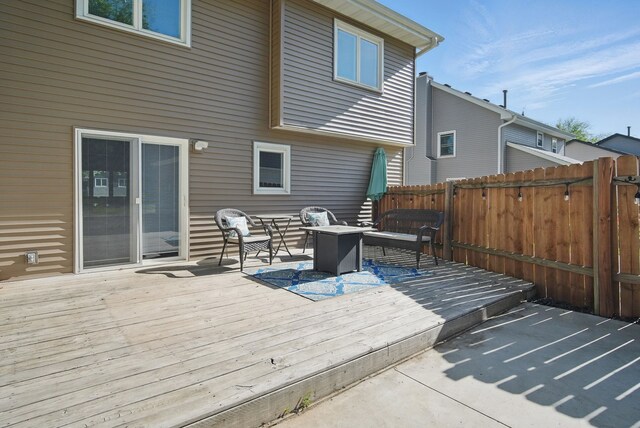 7052 Plum Dr, Urbandale, IA 50322 - wooden terrace featuring an outdoor living space with a fire pit