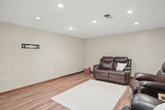 7052 Plum Dr, Urbandale, IA 50322 - living area featuring recessed lighting, light wood-type flooring, and baseboards