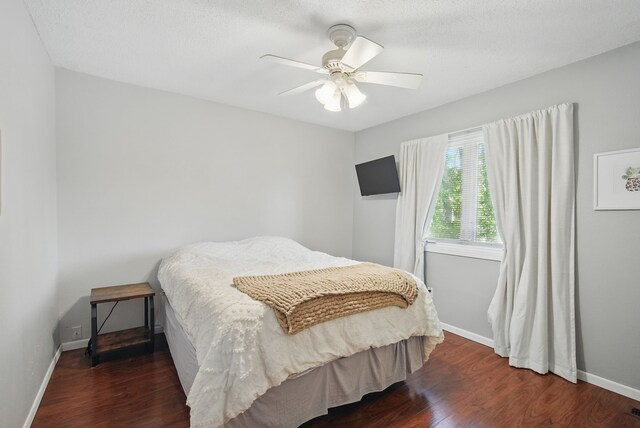 7052 Plum Dr, Urbandale, IA 50322 - bedroom featuring wood finished floors, baseboards, and a ceiling fan