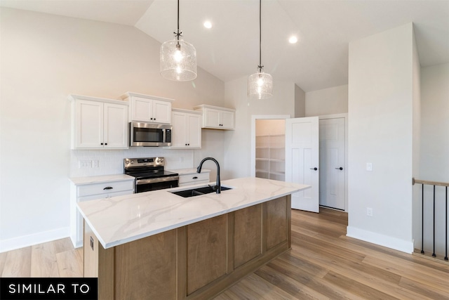 2615 SE Kettleridge Ln, Waukee, IA 50263 - kitchen with a sink, appliances with stainless steel finishes, white cabinets, decorative backsplash, and light stone counters