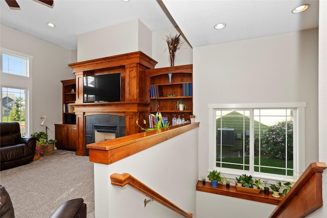 1203 Lynne Dr, Adel, IA 50003 - carpeted living area with a fireplace, recessed lighting, and a ceiling fan