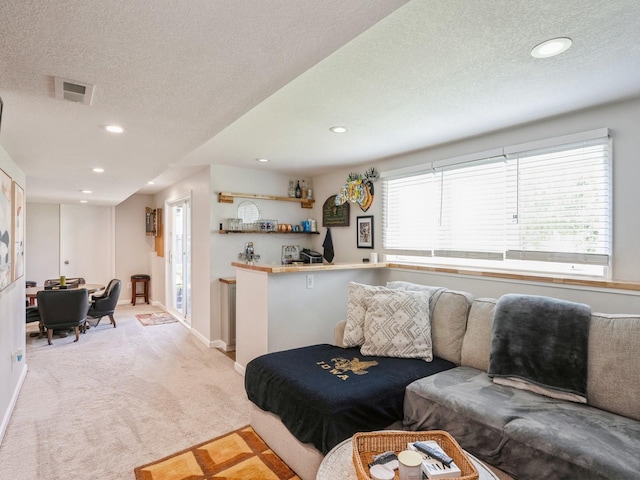 5031 Cherrywood Dr, West Des Moines, IA 50265 - carpeted living room featuring recessed lighting, a textured ceiling, baseboards, and a dry bar
