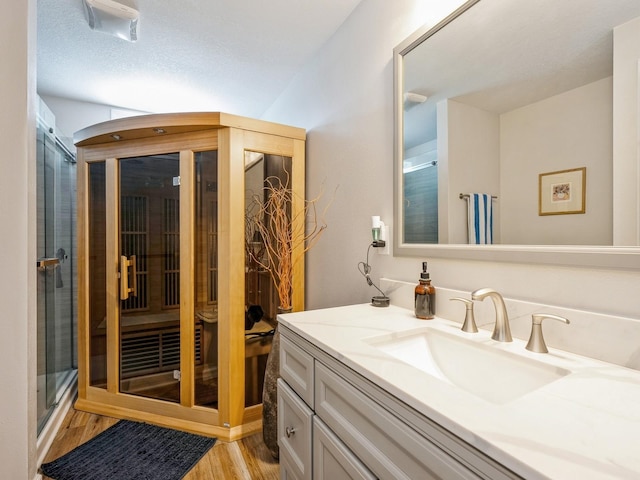 5031 Cherrywood Dr, West Des Moines, IA 50265 - bathroom with wood finished floors, a stall shower, and vanity