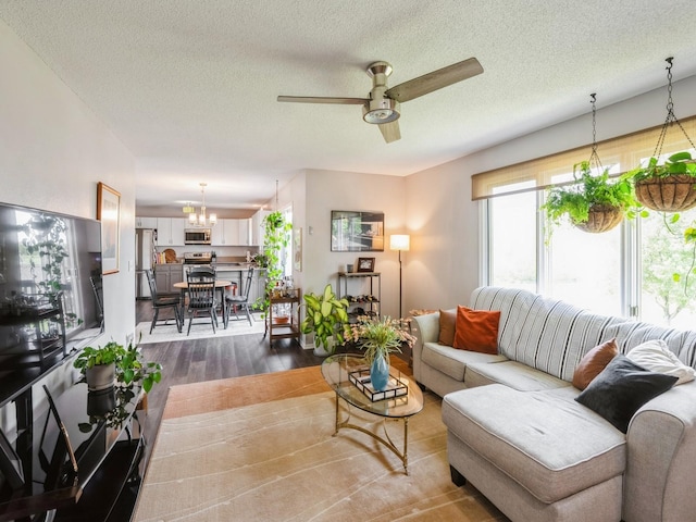 5031 Cherrywood Dr, West Des Moines, IA 50265 - living area featuring dark wood-type flooring, a chandelier, ceiling fan, and a textured ceiling