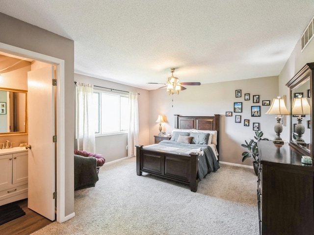 5031 Cherrywood Dr, West Des Moines, IA 50265 - bedroom with carpet flooring, a textured ceiling, baseboards, a sink, and a ceiling fan