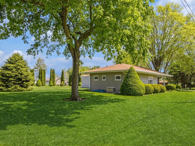 view of grassy yard with central AC unit