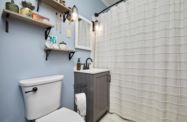 full bathroom with toilet and vanity