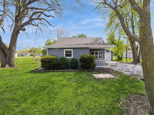 1528 Division St, Boone, IA 50036 - view of side of home featuring a yard, a porch, and roof with shingles