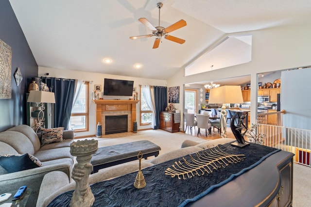 3905 NW 4th St, Ankeny, IA 50023 - living area featuring light carpet, vaulted ceiling, healthy amount of natural light, a ceiling fan, and a tiled fireplace