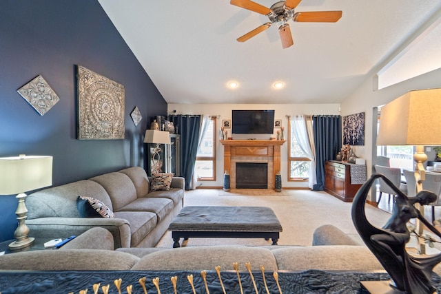 3905 NW 4th St, Ankeny, IA 50023 - carpeted living area with lofted ceiling, ceiling fan, and a tiled fireplace
