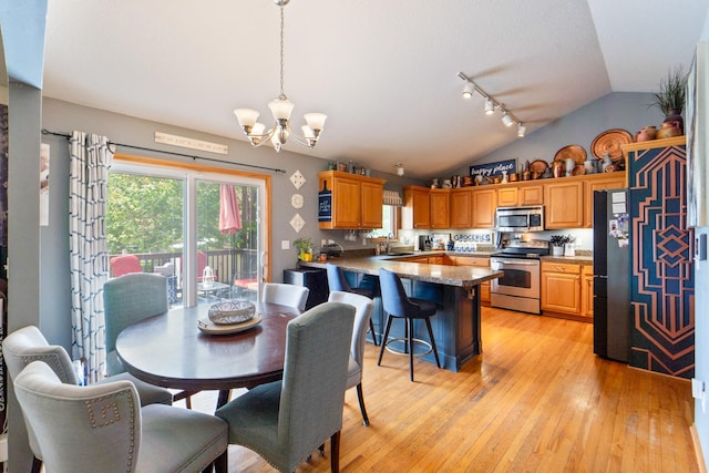 3905 NW 4th St, Ankeny, IA 50023 - dining area with vaulted ceiling, light wood finished floors, a chandelier, and track lighting