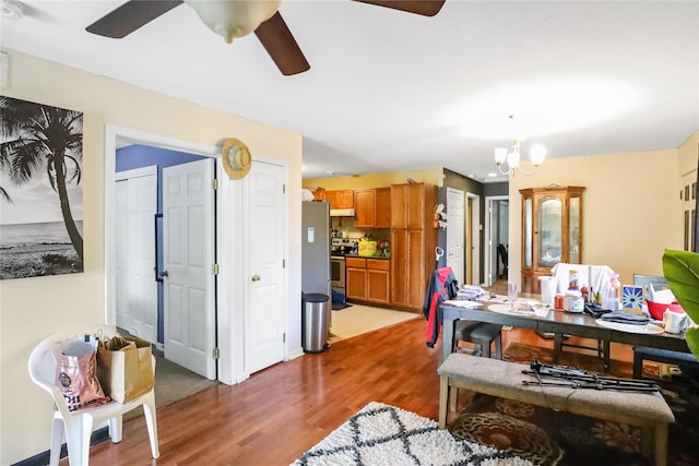 1424 Cleveland Ave, Des Moines, IA 50316 - dining space featuring a ceiling fan, light wood-type flooring, and a chandelier