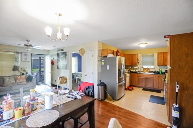 1424 Cleveland Ave, Des Moines, IA 50316 - dining space featuring a chandelier, healthy amount of natural light, light wood-style flooring, and ceiling fan