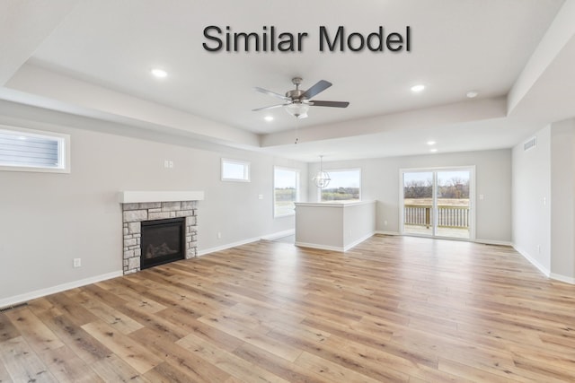 unfurnished living room featuring light wood-type flooring, a ceiling fan, recessed lighting, baseboards, and a fireplace