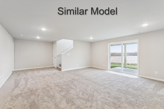 unfurnished living room featuring carpet flooring, stairs, recessed lighting, and baseboards