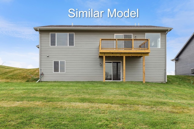 rear view of property featuring a lawn and a wooden deck