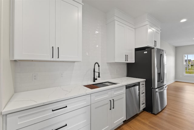 1998 S Warrior Ln, Waukee, IA 50263 - kitchen featuring a sink, stainless steel appliances, white cabinetry, decorative backsplash, and recessed lighting