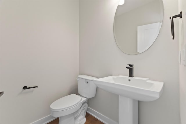 1998 S Warrior Ln, Waukee, IA 50263 - bathroom featuring baseboards, wood finished floors, and toilet