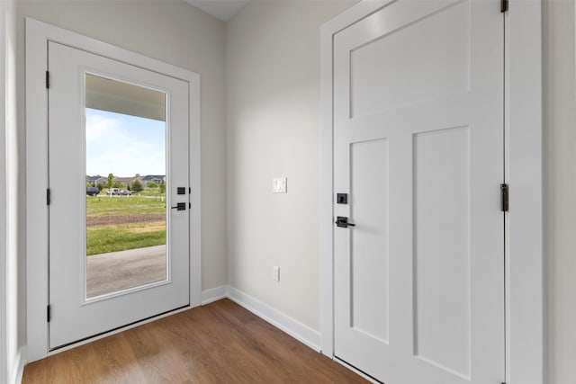 1998 S Warrior Ln, Waukee, IA 50263 - doorway with dark wood-style floors and baseboards