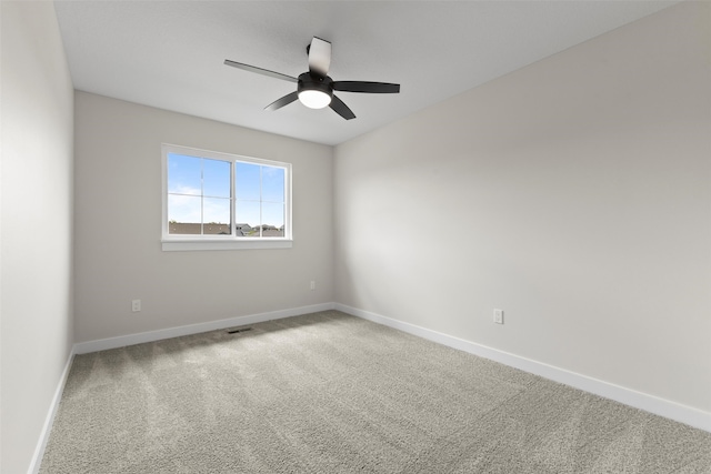 1998 S Warrior Ln, Waukee, IA 50263 - spare room featuring a ceiling fan, carpet flooring, and baseboards