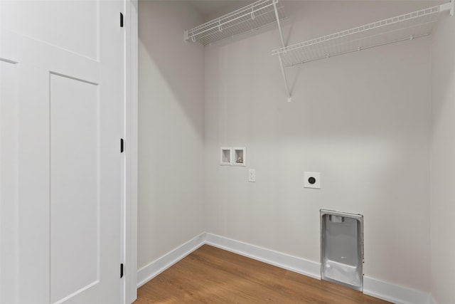 1998 S Warrior Ln, Waukee, IA 50263 - washroom featuring washer hookup, electric dryer hookup, wood finished floors, and baseboards