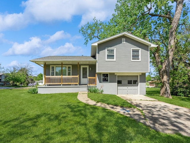 tri-level home with covered porch, concrete driveway, a garage, and a front lawn