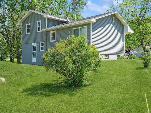 view of home's exterior featuring a yard