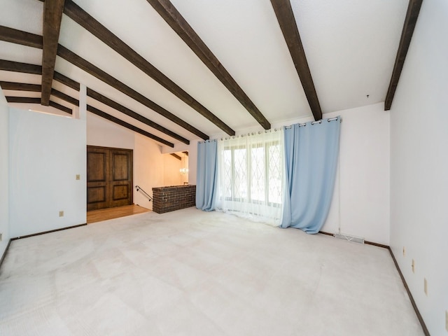 unfurnished living room featuring carpet floors and baseboards