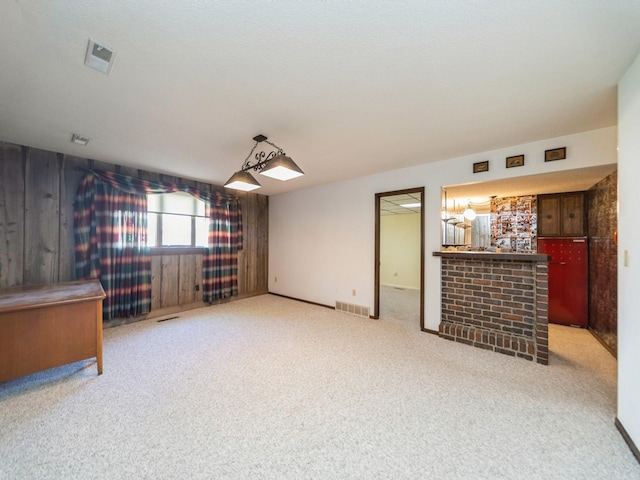 spare room featuring light colored carpet and bar
