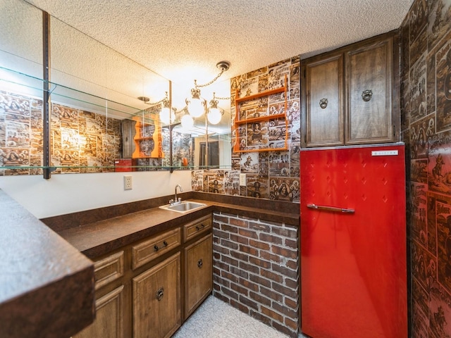 indoor wet bar with light colored carpet and a textured ceiling