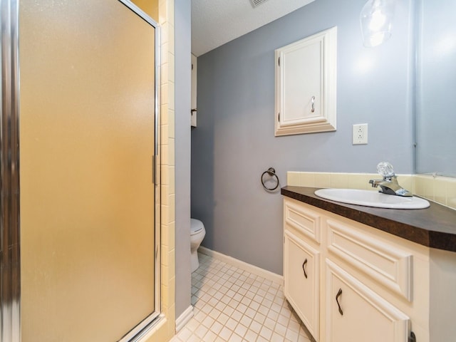 full bath with a stall shower, tile patterned flooring, toilet, and vanity
