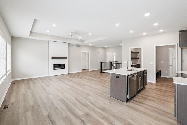 2331 N 8th Ave E, Newton, IA 50208 - kitchen featuring a ceiling fan, stainless steel dishwasher, light countertops, recessed lighting, and a tray ceiling