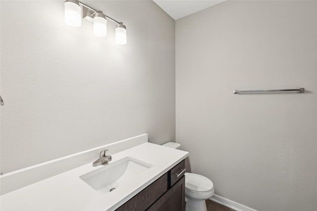 2331 N 8th Ave E, Newton, IA 50208 - bathroom featuring toilet, vanity, and baseboards