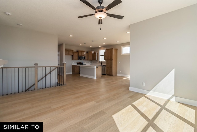 4416 NE 8th St, Ankeny, IA 50021 - unfurnished living room featuring ceiling fan, light wood finished floors, recessed lighting, and baseboards