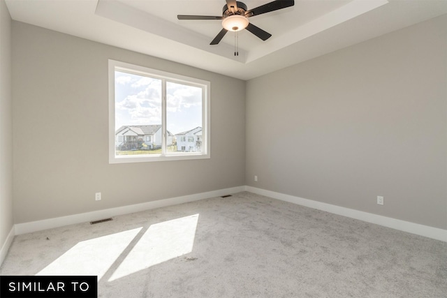 4416 NE 8th St, Ankeny, IA 50021 - spare room featuring carpet flooring, a tray ceiling, and baseboards