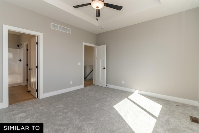 4416 NE 8th St, Ankeny, IA 50021 - unfurnished bedroom with carpet floors, baseboards, and a tray ceiling