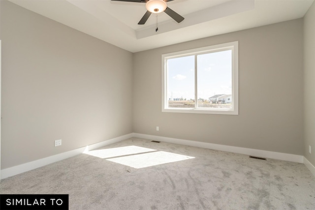 4416 NE 8th St, Ankeny, IA 50021 - carpeted spare room with baseboards, a tray ceiling, and ceiling fan