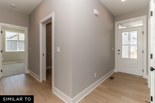 4416 NE 8th St, Ankeny, IA 50021 - doorway featuring light wood-style floors, plenty of natural light, and baseboards