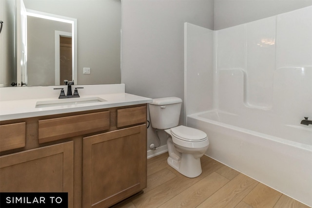 4416 NE 8th St, Ankeny, IA 50021 - bathroom with toilet, wood finished floors, vanity, and shower / washtub combination