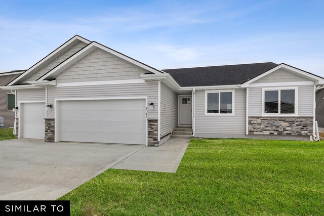 4404 NE 8th St, Ankeny, IA 50021 - view of front of property featuring stone siding, an attached garage, a front yard, and driveway