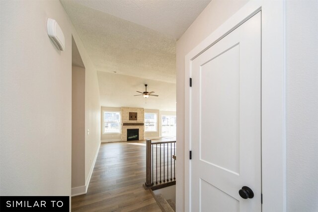 4404 NE 8th St, Ankeny, IA 50021 - hallway with a textured ceiling, dark wood-style flooring, and baseboards