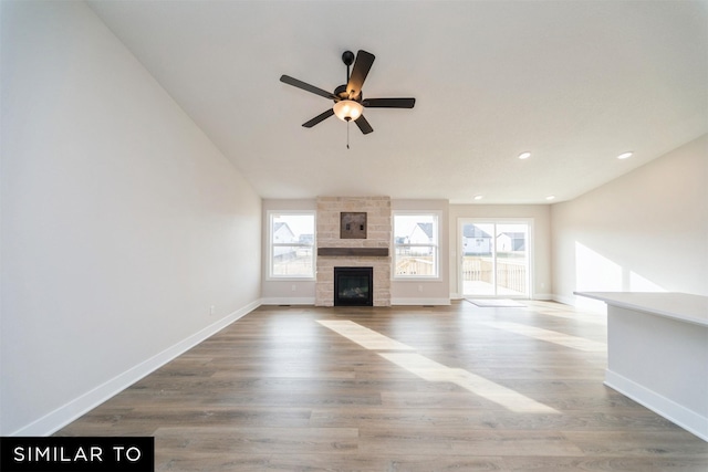 4404 NE 8th St, Ankeny, IA 50021 - unfurnished living room with a ceiling fan, a large fireplace, baseboards, wood finished floors, and recessed lighting